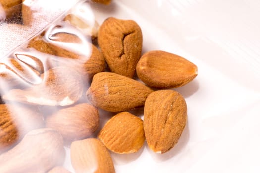 almonds packages in plastic packaging isoalted on white background