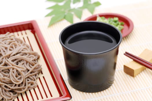 Japanese Zaru soba noodles in a ceramic bowl on white background