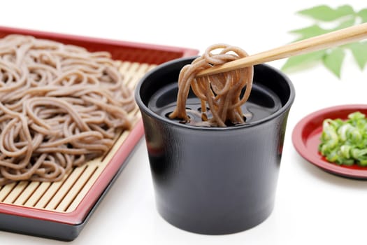Japanese Zaru soba noodles in a ceramic bowl on white background