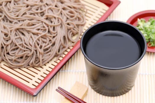 Japanese Zaru soba noodles in a ceramic bowl on white background