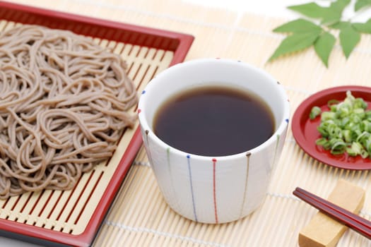Japanese Zaru soba noodles in a ceramic bowl on white background