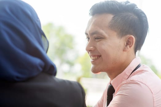 Portrait of business people talking and smiling.