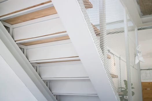 Wooden and white metal staircase, stock photo