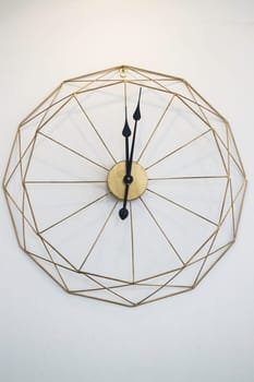 Vintage clock on white wall background, stock photo