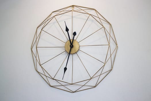 Vintage clock on white wall background, stock photo