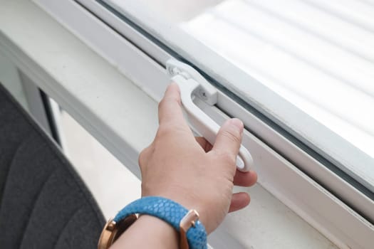 Woman hand opening see through window, stock photo