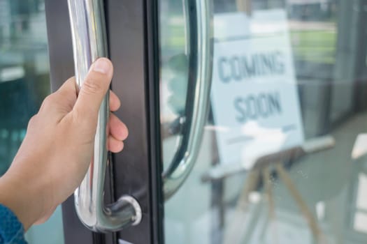 Woman hand opening see through door, stock photo