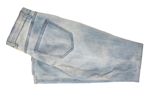 Woman jeans isolated. Folded trendy stylish female blue jeans trousers isolated on a white background. Fashionable denim pants for women.