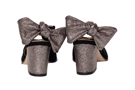 Leather shoes isolated. Close-up of a pair of elegant female suede shoes decorated with silver bows isolated on a white background. Shoe fashion 2019. Macro back view.