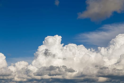 Cumulus clouds of white-gray color against a blue sky after a thunderstorm
