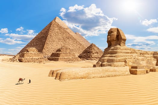 The Pyramids and the Sphinx in the sunny desert of Giza, Egypt.