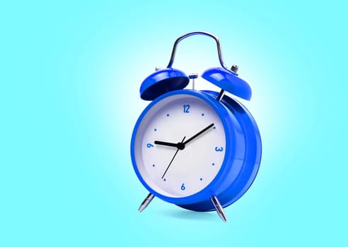 Blue alarm clock isolated on blue background. With clipping path
