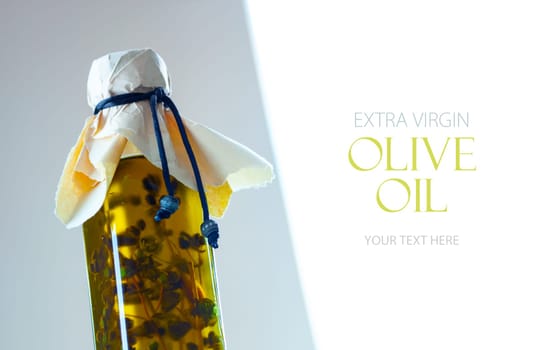 Olive oil in a bottle with fragrant herbs. Template design with sample text