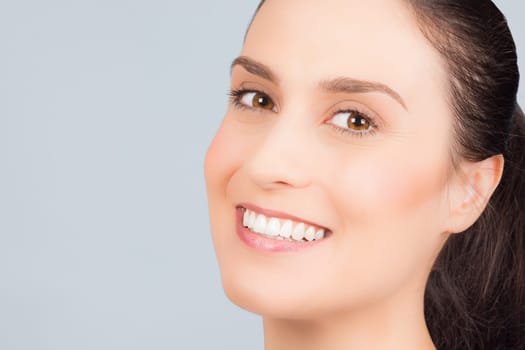 Beautiful smiling woman has perfect skin in 30s, anti-age treatment concept.