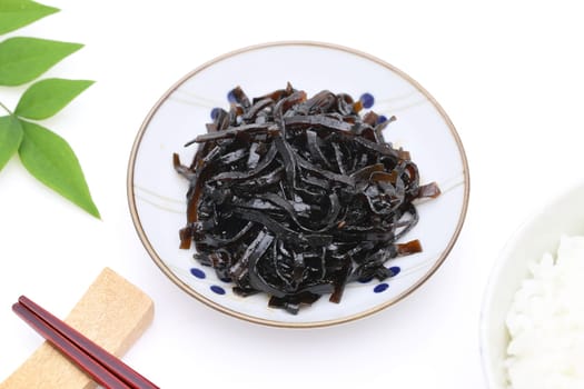 Japanese food, Tsukudani of seaweed konbu in a dish on white background