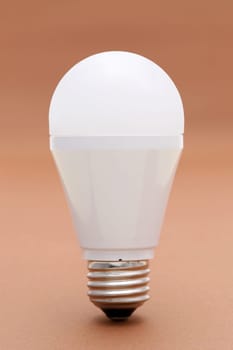 LED energy saving bulb on brown background