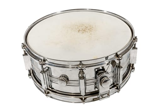 Old silver Snare drum stands on the ground isolated on white