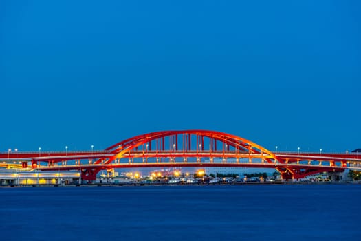 Red kobe port monorail bridge at sunset twilight in Kobe Hyogo Japan