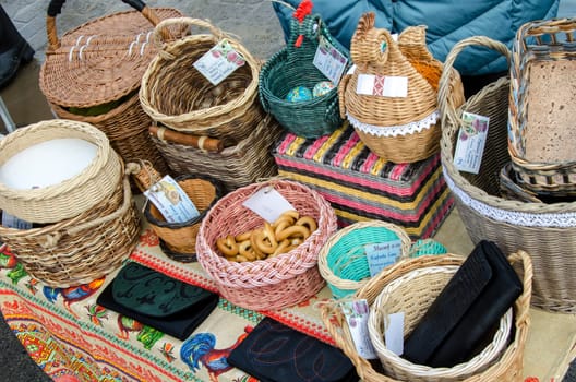 Ceramic plates, hand-painted with a dot pattern, are on the counter at the festive fair