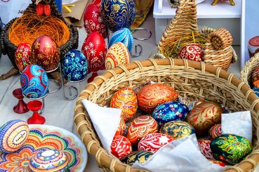 Ceramic plates, hand-painted with a dot pattern, are on the counter at the festive fair