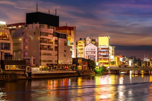 Fukuoka old town along naka river at Nakasukawabata sunset twilight. This area is favorite for tourist for Fukuoka Yatai, street Food stall,  for hangout at night.