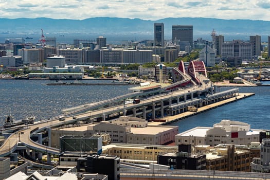 Aerial view of Kobe cityscape and red bridge at port area in Kobe downtown Hyogo Japan