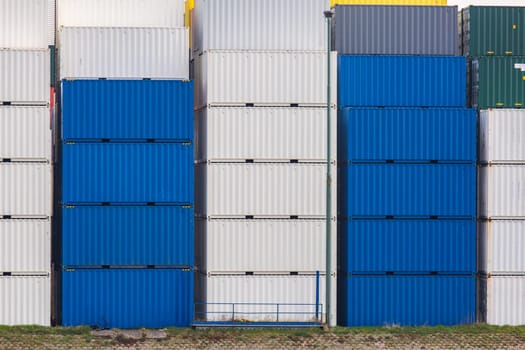 Cargo Containers Goods Stack at the Pier docks port waiting for international sea freight transportation in Rotterdam Port of Netherlands