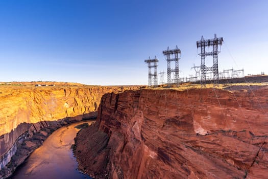 Power plant house and power line over Electricity generating dam with river colorado in Page Arizona USA