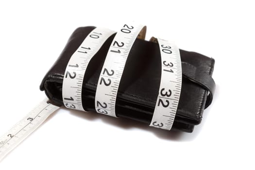 concept of budget and money. Purse is tied with measuring tape on white background
