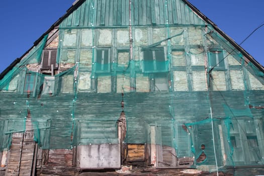 Green safety net on old building facade