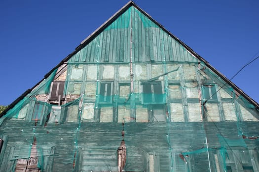 Green safety net on old building facade