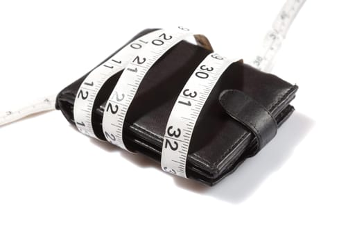 concept of budget and money. Purse is tied with measuring tape on white background