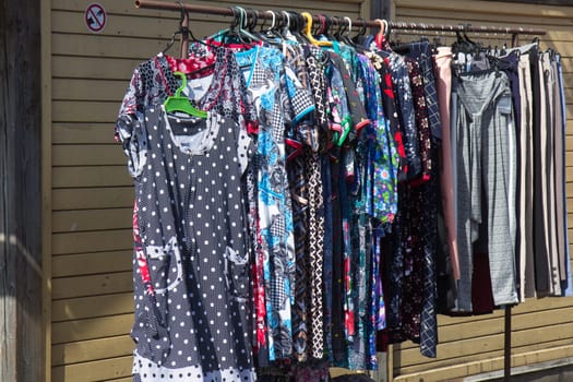 various clothing hung in sale on flea market