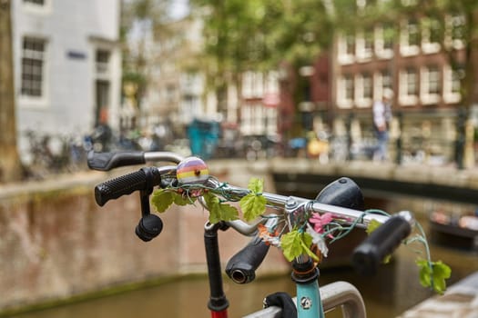 AMSTERDAM, NETHERLANDS - SEPTEMBER 21, 2017: Bicycle as popular way of transport in Amsterdam Netherlands parked and locked in front of traditional house in Holland.