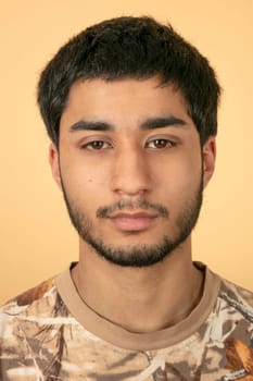 Beautiful black haired man on beige background