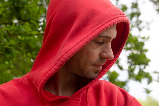 Portrait from young man with red hoodie looking real serious