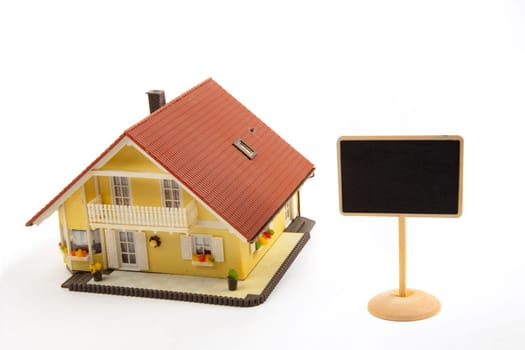 Toy House and little Blackboard Sign on white Background