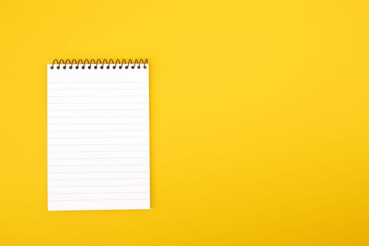 Top View Paper Notepad on yellow cardboard