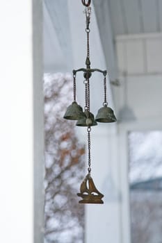 Metal bells hanging from the eaves of balcony