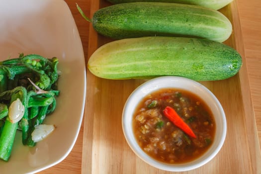 Thai cuisine nam prik or chili paste with vegetables on wooden