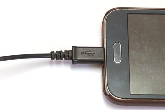 close up smartphone charging on white background