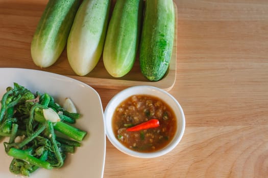 Thai cuisine nam prik or chili paste with vegetables on wooden