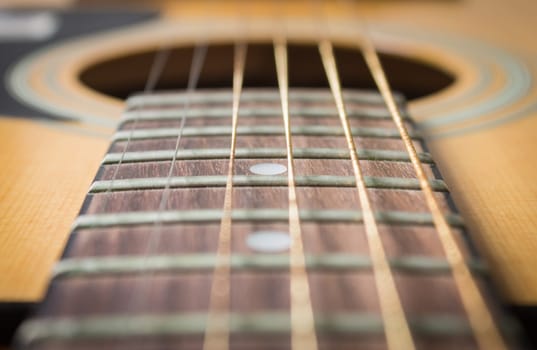 Close Up Fingerboard and Inlay of 6 String Brown Wood Acoustic Guitar