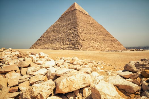 Ruins in Giza desert and the Pyramid of Chephren, Egypt.