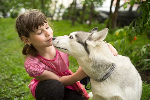 The girl wants to kiss the dog.