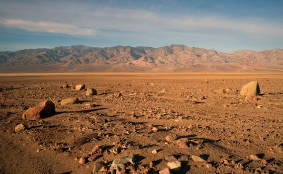 The sun rises to light the dry basin in Death Valley