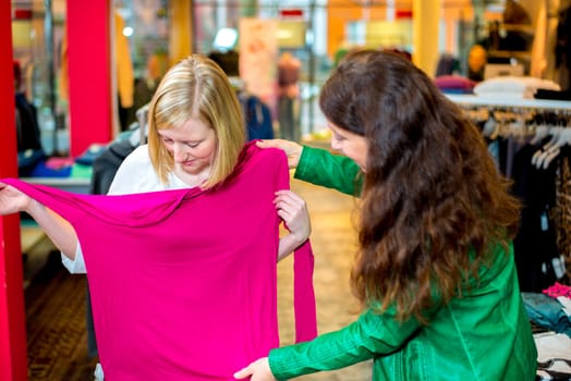 two women in the clothes shop looking for outfit