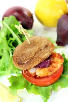 Shrimp burger with tomato,red onion and salad