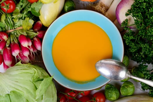 plate of pumpkin soup with  several vegetables