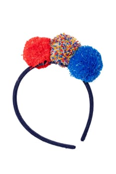 Clothes for children. Close-up of colored hairband with colorful fluffy fabric balls for the little girl isolated on a white background. Macro.